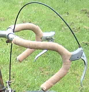 Old handlebar shape and interesting right brake lever with thumbwheel adjustment.